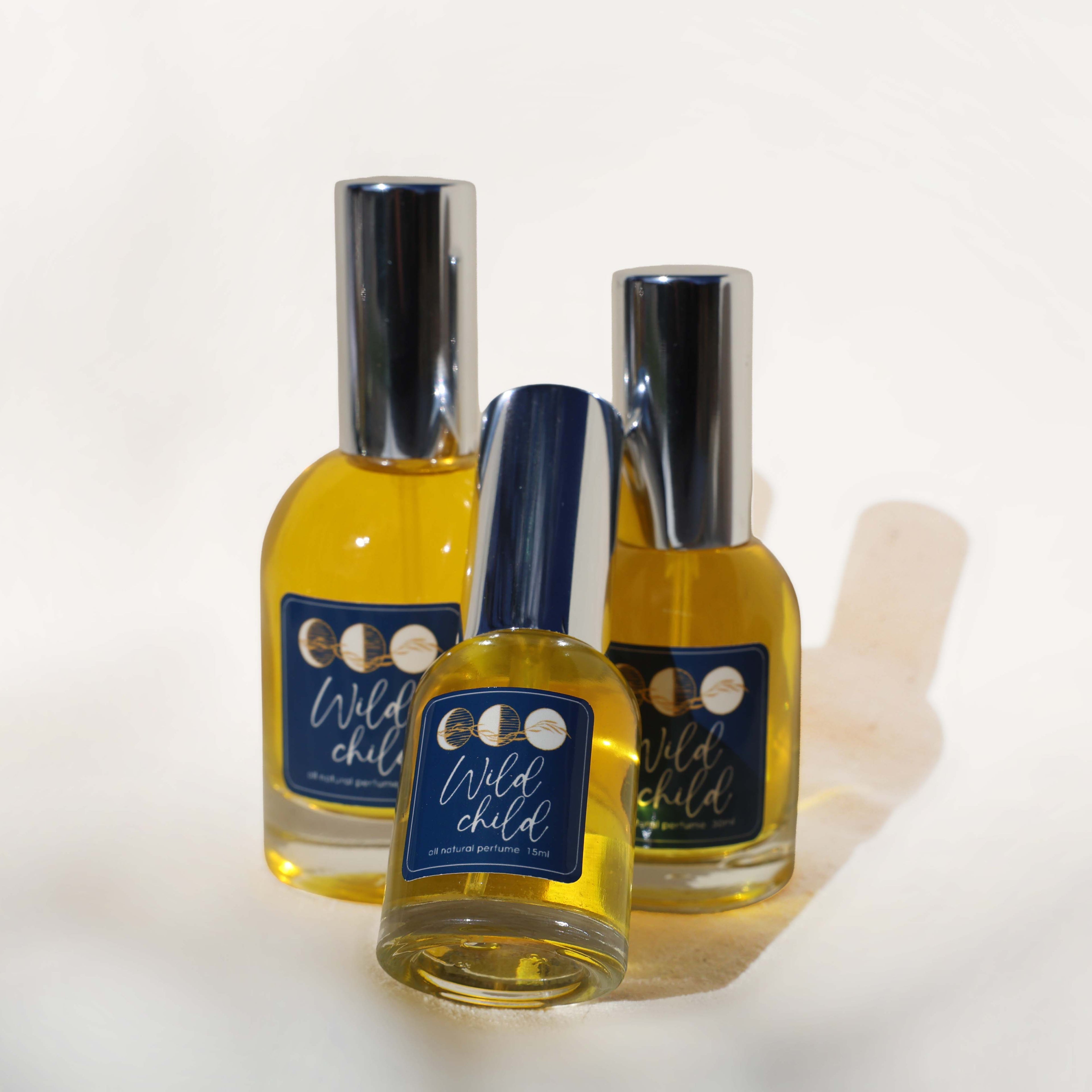 Three small bottles of Rock Creek perfume on a white background