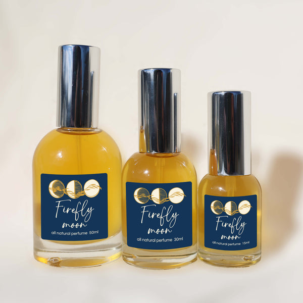Three bottles of 'Firefly Moon' perfume on a white background