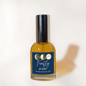 Perfume bottle labeled 'Firefly Moon' on a white background