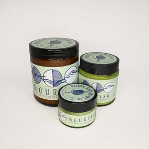 Three jars of Nourish Dry Skin Lotion on a white background
