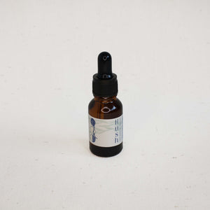 Brown glass dropper bottle with label on a white background