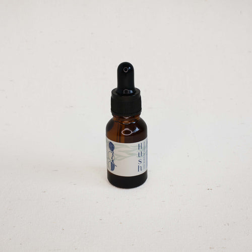 Brown glass dropper bottle with label on a white background