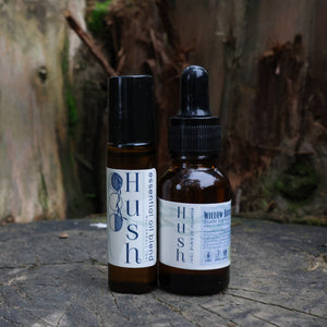 Two Hush bottles on a wooden surface with a natural background