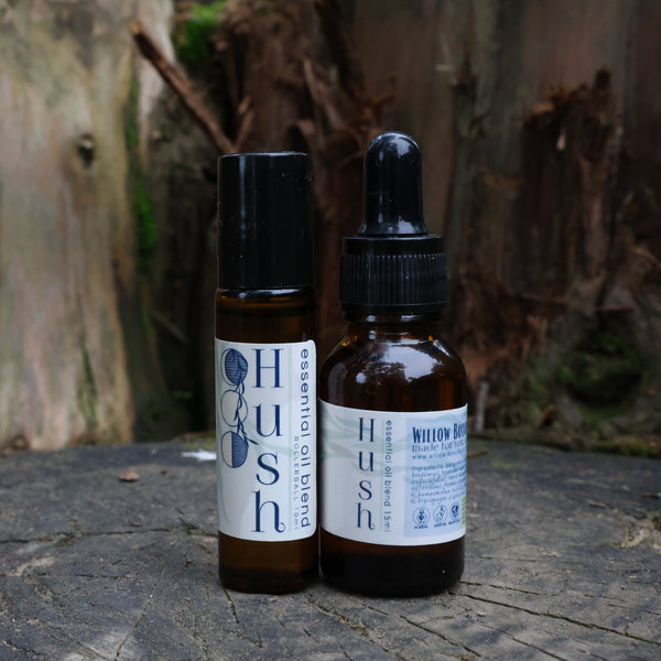 Two Hush bottles on a wooden surface with a natural background